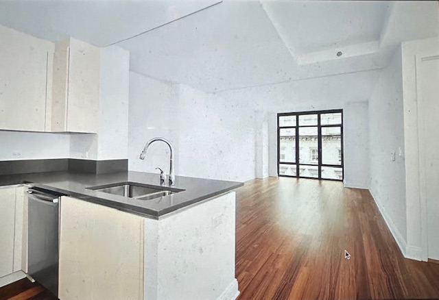 57 Reade Street, Unit 7A Manhattan, NY 10007 - Photo 1 of 5 a kitchen with granite countertop a sink and wooden floor