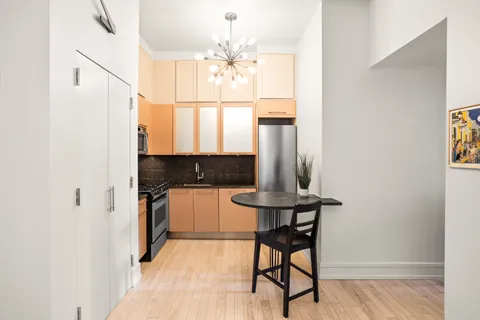 a bathroom with a light fixture a sink and a mirror