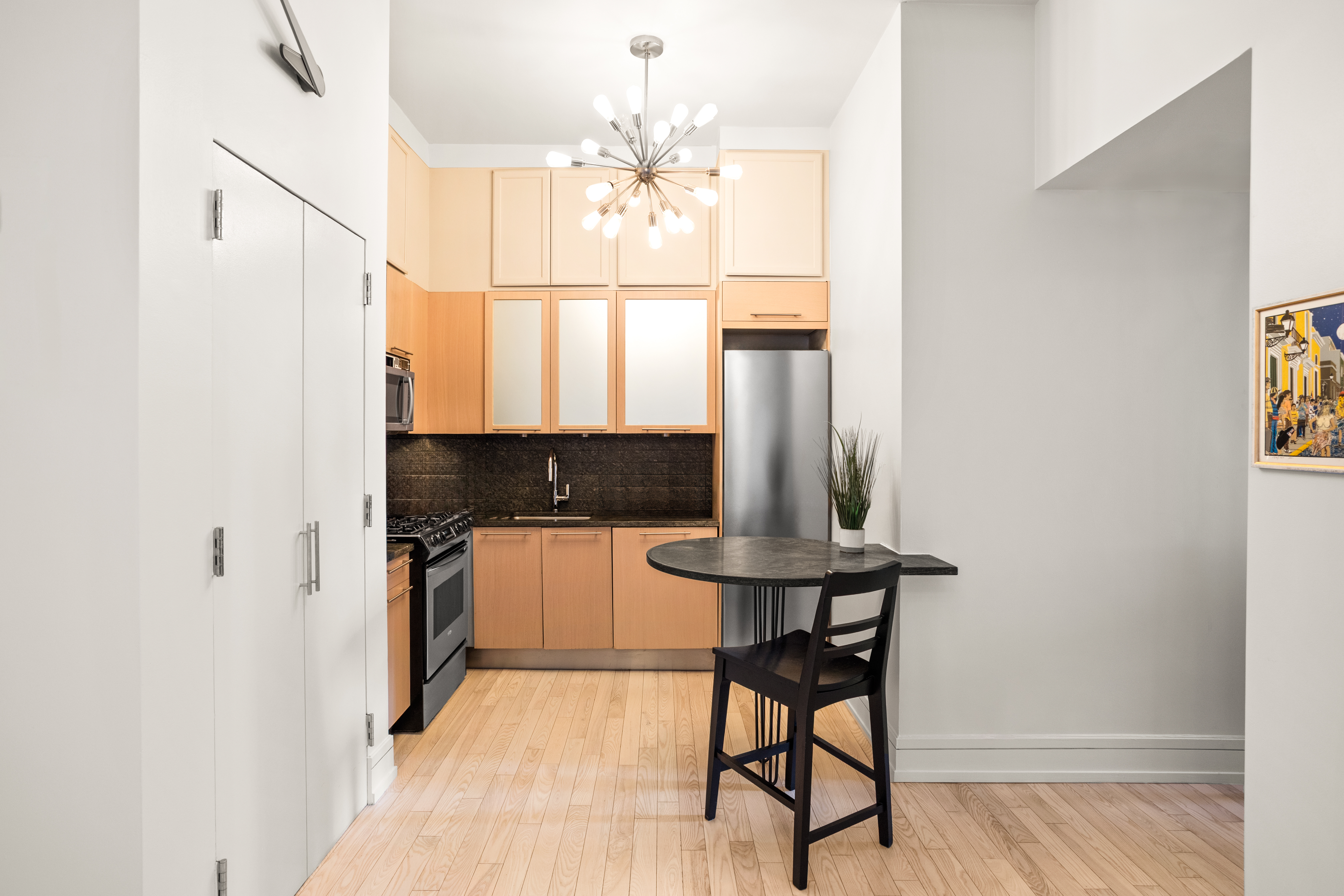 120 Greenwich Street, Unit 5H Manhattan, NY 10006 - Photo 3 of 6 a bathroom with a light fixture a sink and a mirror