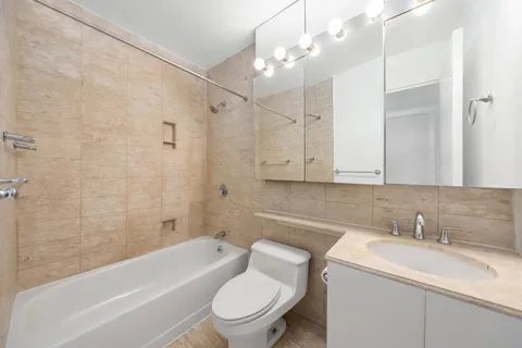 a bathroom with a sink a toilet and bathtub