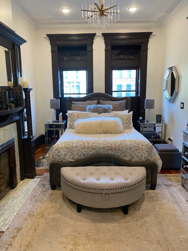 a large bedroom with a bed and a fireplace