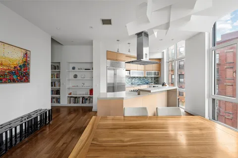 a view of a living room a dining room wooden floor and a window