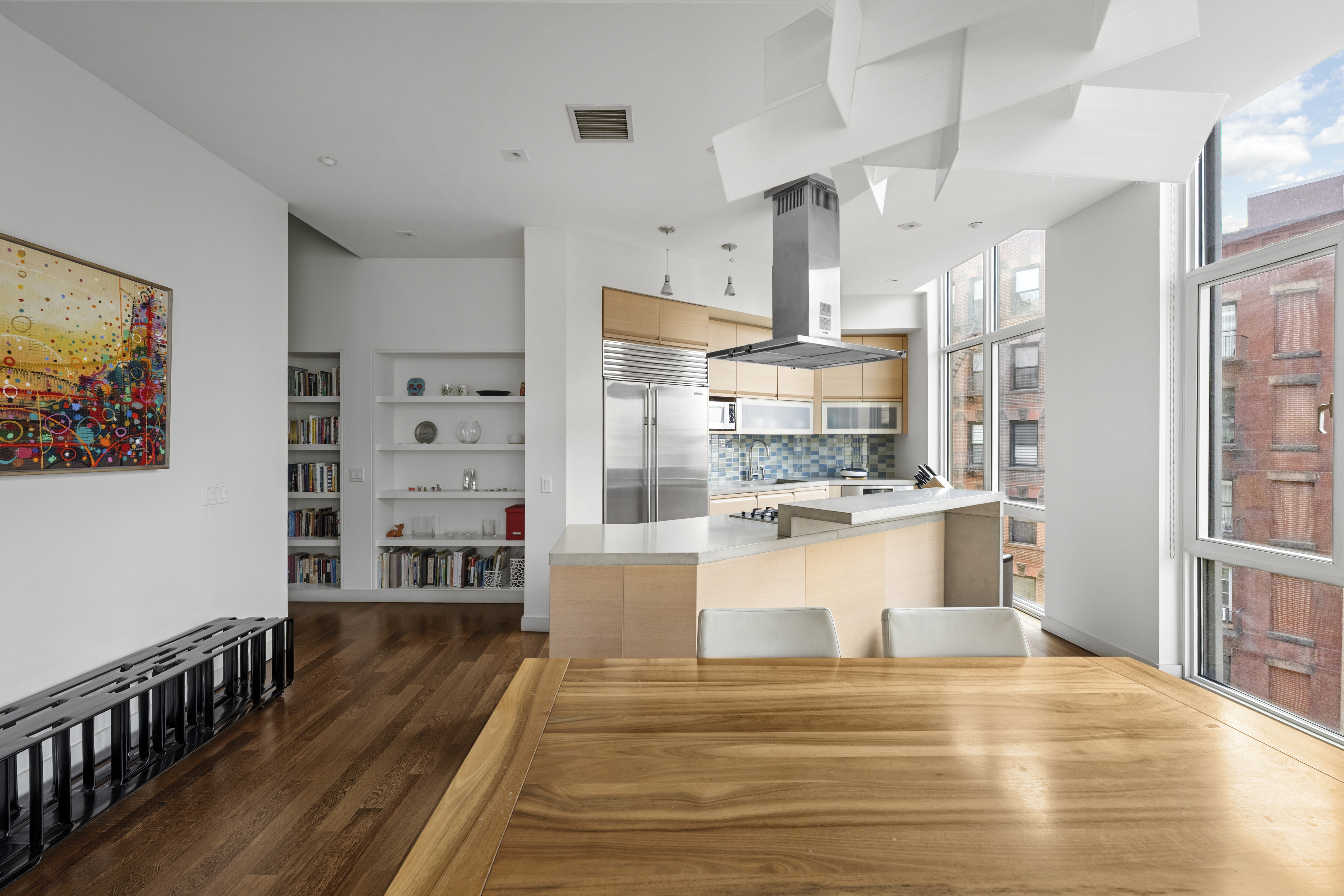 475 Greenwich Street, Unit 5B Manhattan, NY 10013 - Photo 4 of 16 a view of a living room a dining room wooden floor and a window