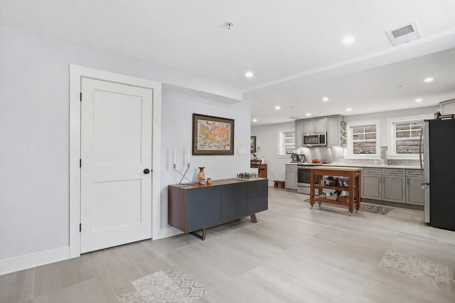 1244 Raum Street Northeast, Unit 5 Washington, DC 20002 - Photo 2 of 21 a living room with furniture and a dining table with kitchen view