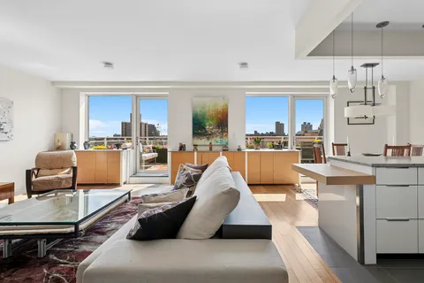 a living room with furniture and kitchen view