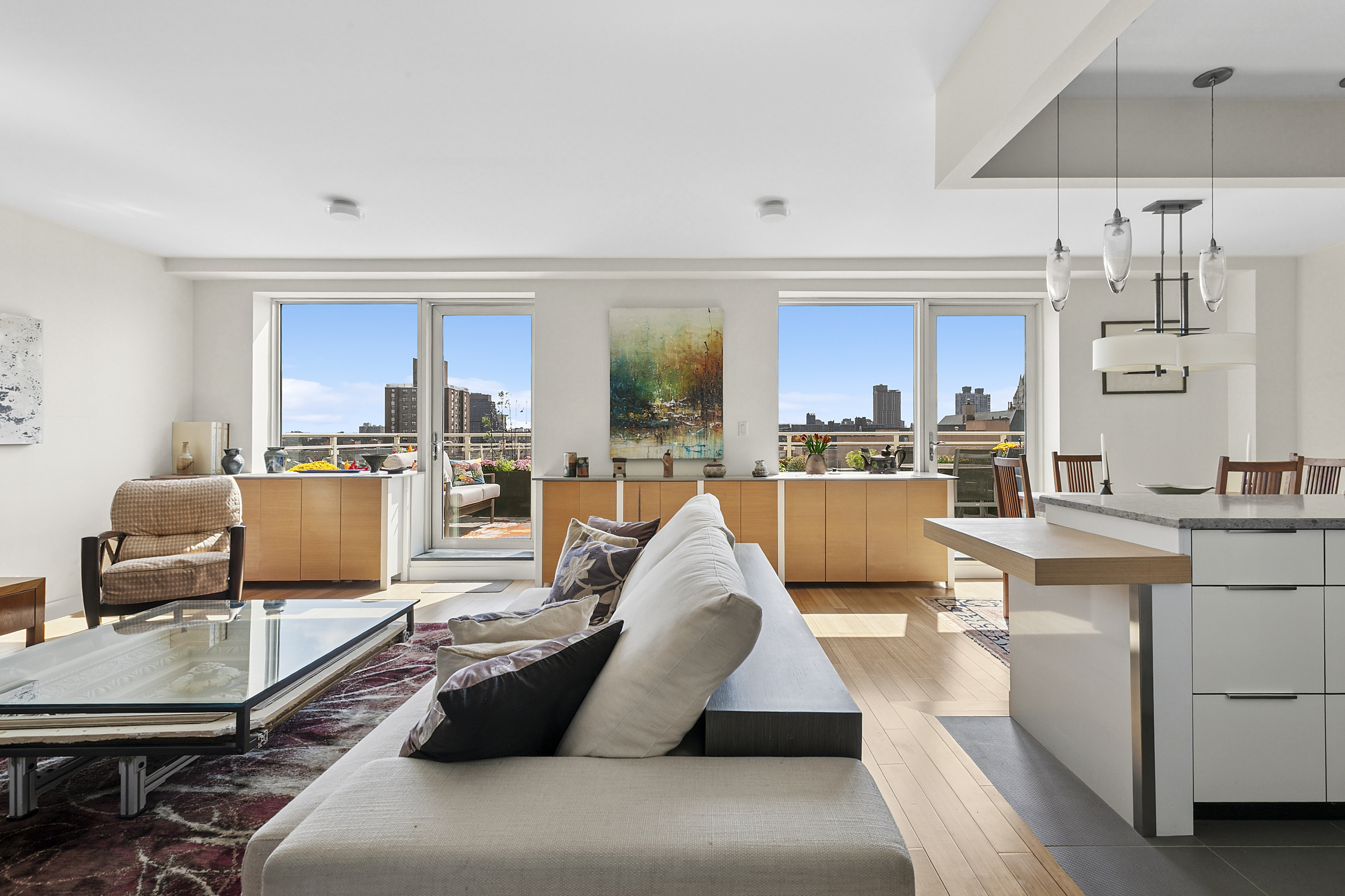 301 West 115th Street, Unit PH1C Manhattan, NY 10026 - Photo 2 of 12 a living room with furniture and kitchen view