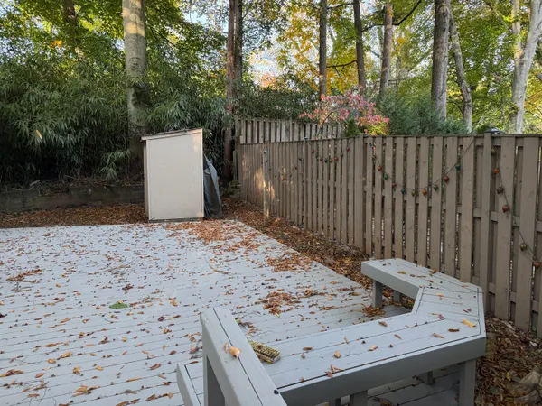 a view of a backyard with wooden fence