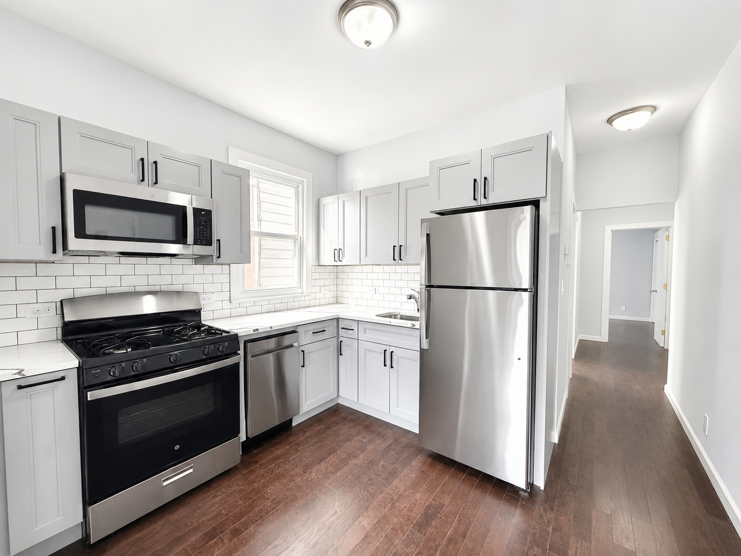 1675 85th Street, Unit 1F Brooklyn, NY 11214 - Photo 1 of 7 a kitchen with a refrigerator stove and wooden cabinets