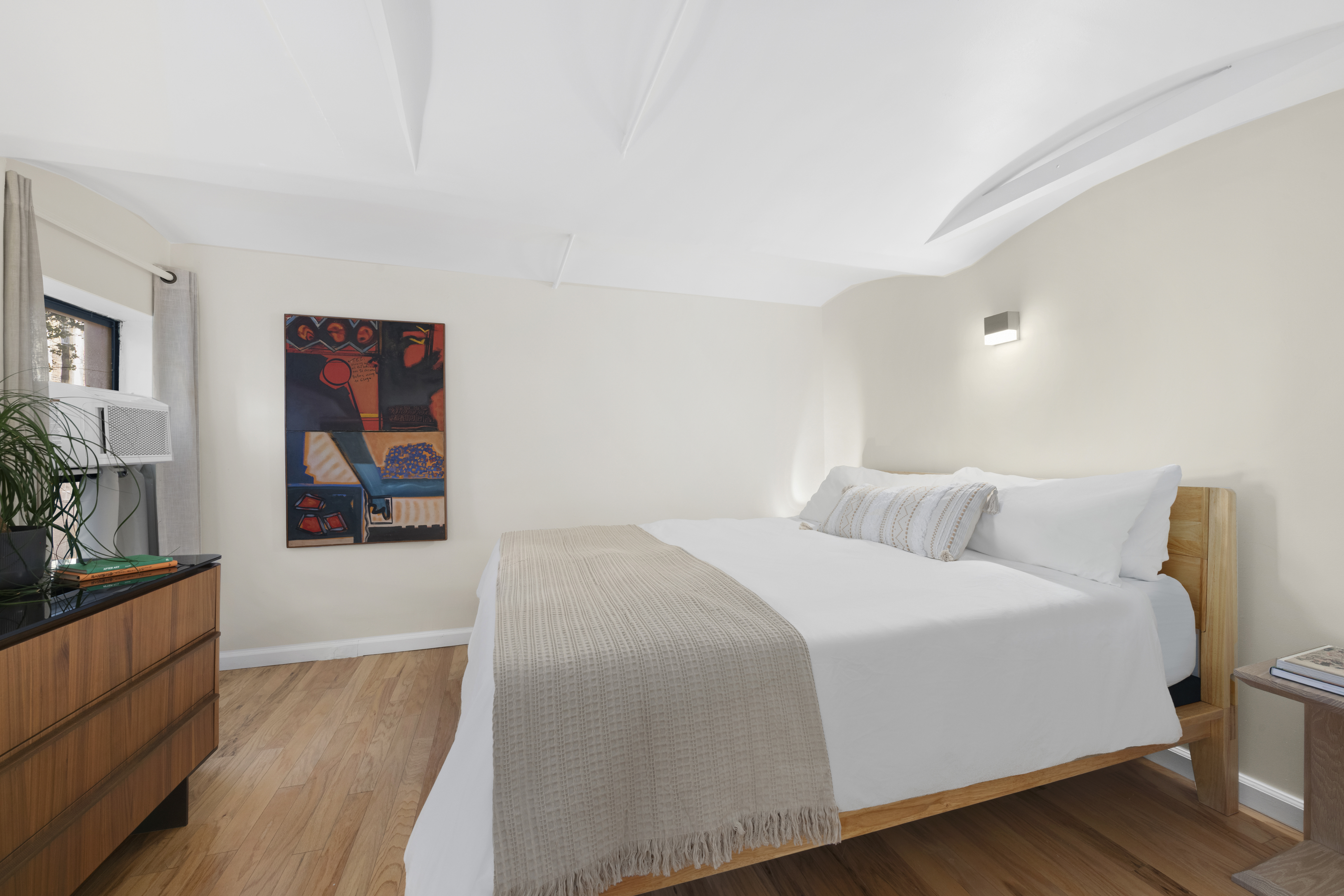 309 East 108th Street, Unit 2/D Manhattan, NY 10029 - Photo 6 of 12 a bedroom with a bed and a dresser