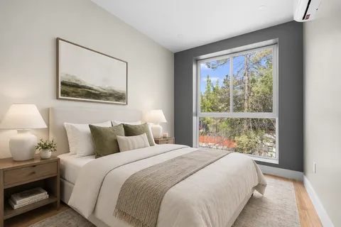 a bedroom with a bed and a painting on the wall