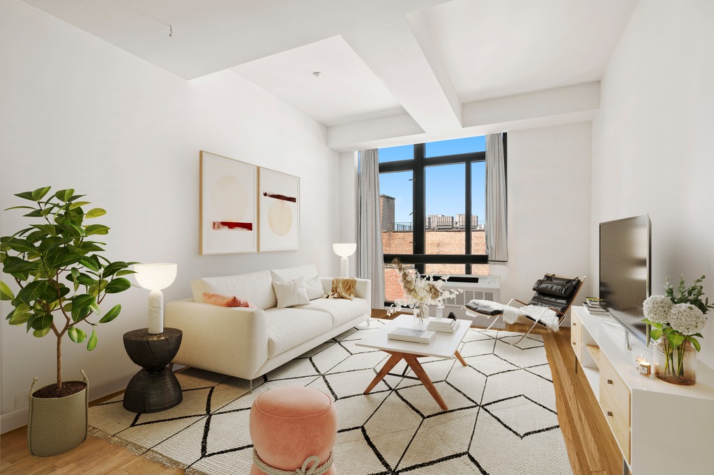 a living room with furniture and a potted plant