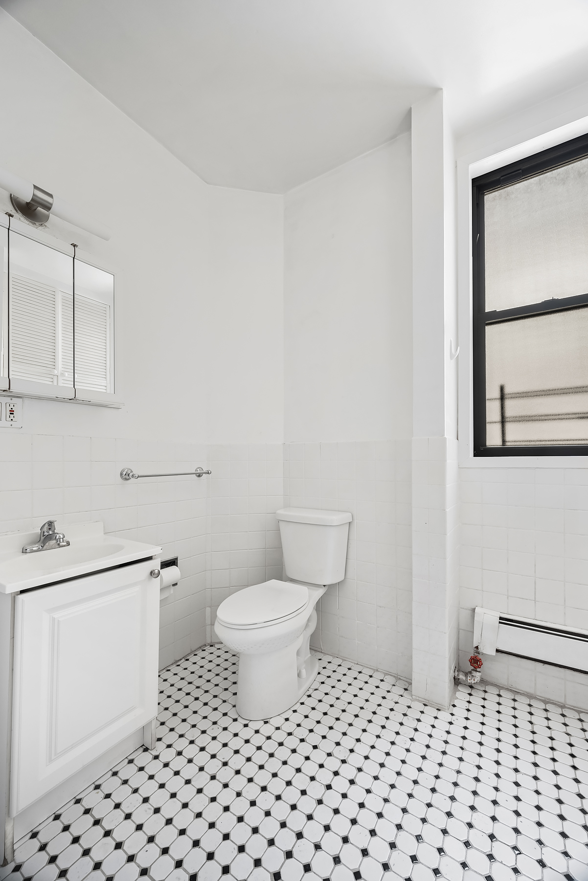 862 West End Avenue, Unit 2R Manhattan, NY 10025 - Photo 6 of 8 a bathroom with a toilet a sink and a mirror