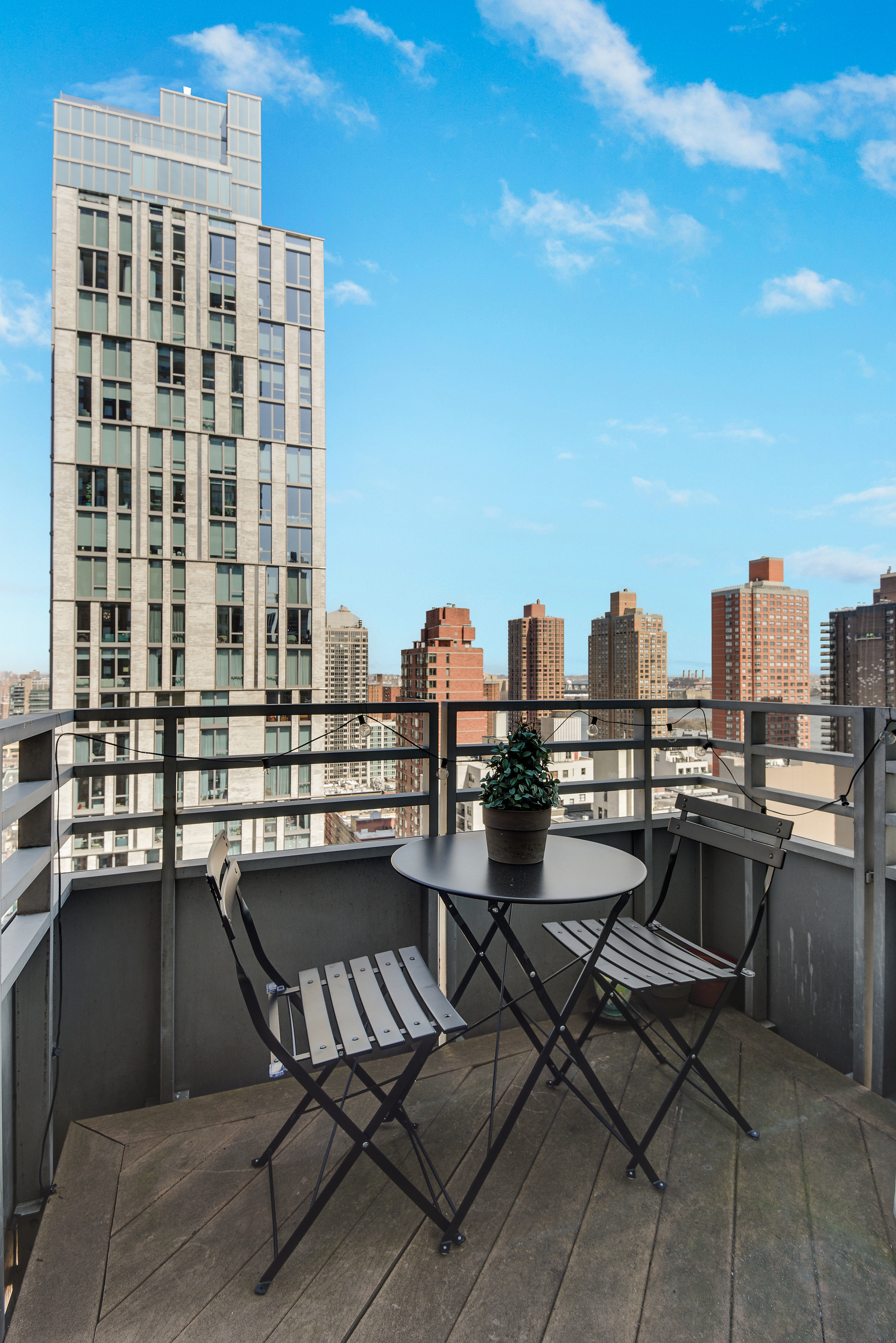 360 East 88th Street, Unit 22C Manhattan, NY 10128 - Photo 14 of 33 a view of a balcony with chairs