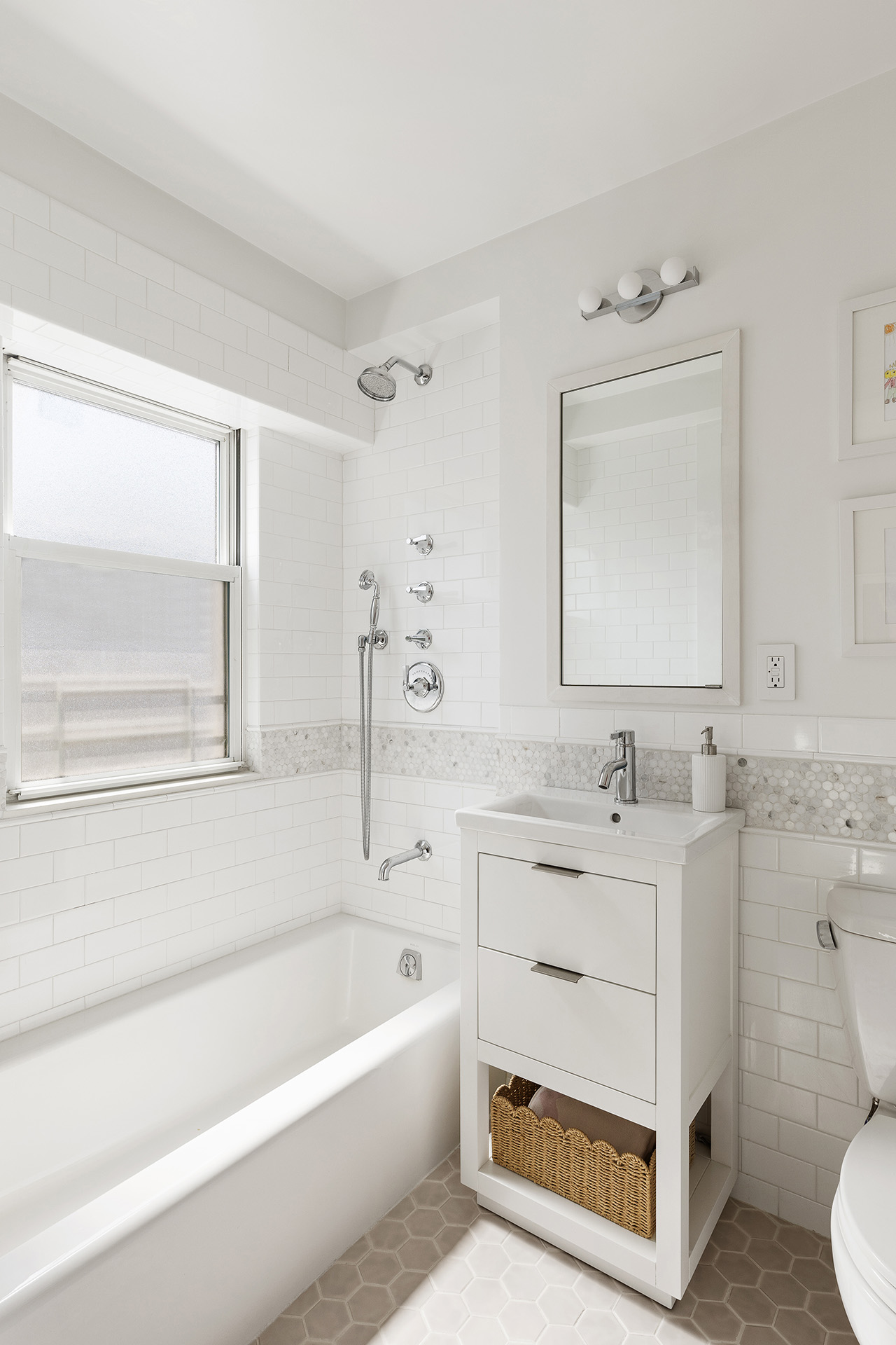 101 West 12th Street, Unit 8RS Manhattan, NY 10011 - Photo 13 of 19 a bathroom with a sink vanity tub and a mirror