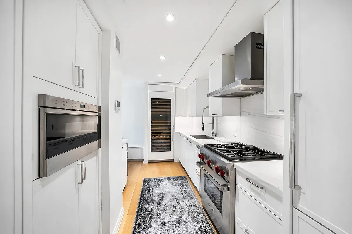 a kitchen with stainless steel appliances a stove a microwave and cabinets