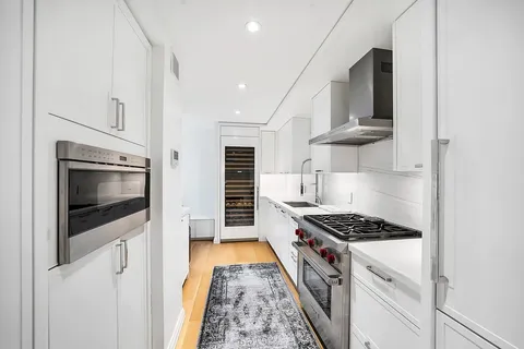 a kitchen with stainless steel appliances a stove a microwave and cabinets