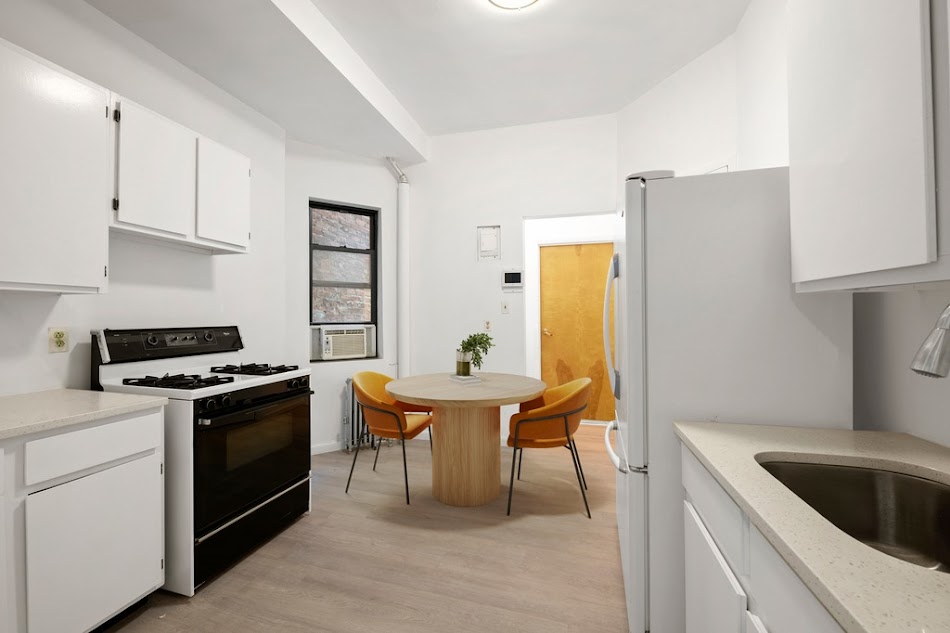 312 West 49th Street, Unit 1RW Manhattan, NY 10019 - Photo 9 of 12 a kitchen with a stove a refrigerator and a sink