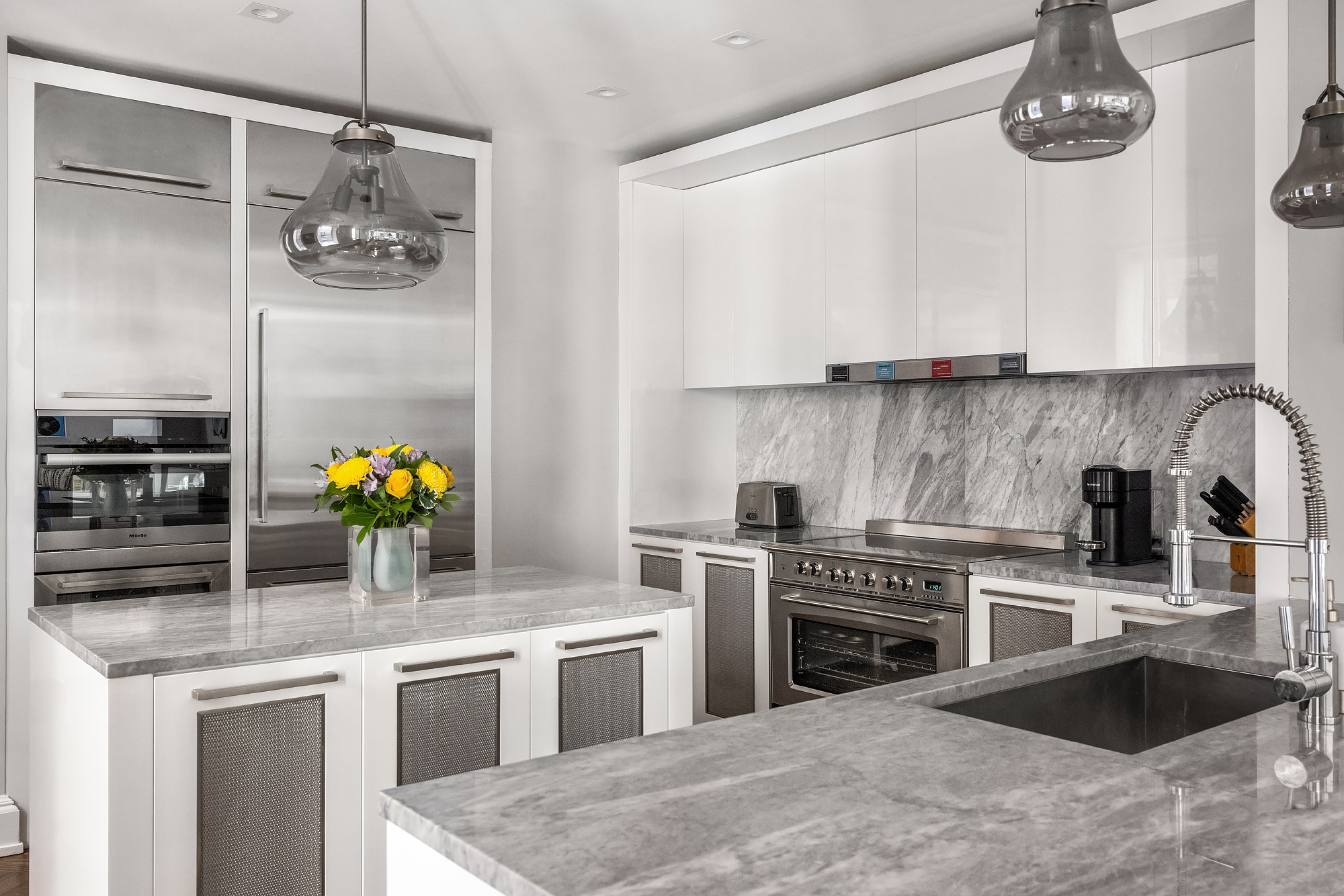 344 West 72nd Street, Unit 1007 Manhattan, NY 10023 - Photo 4 of 23 a kitchen with stainless steel appliances granite countertop a sink a stove and cabinets