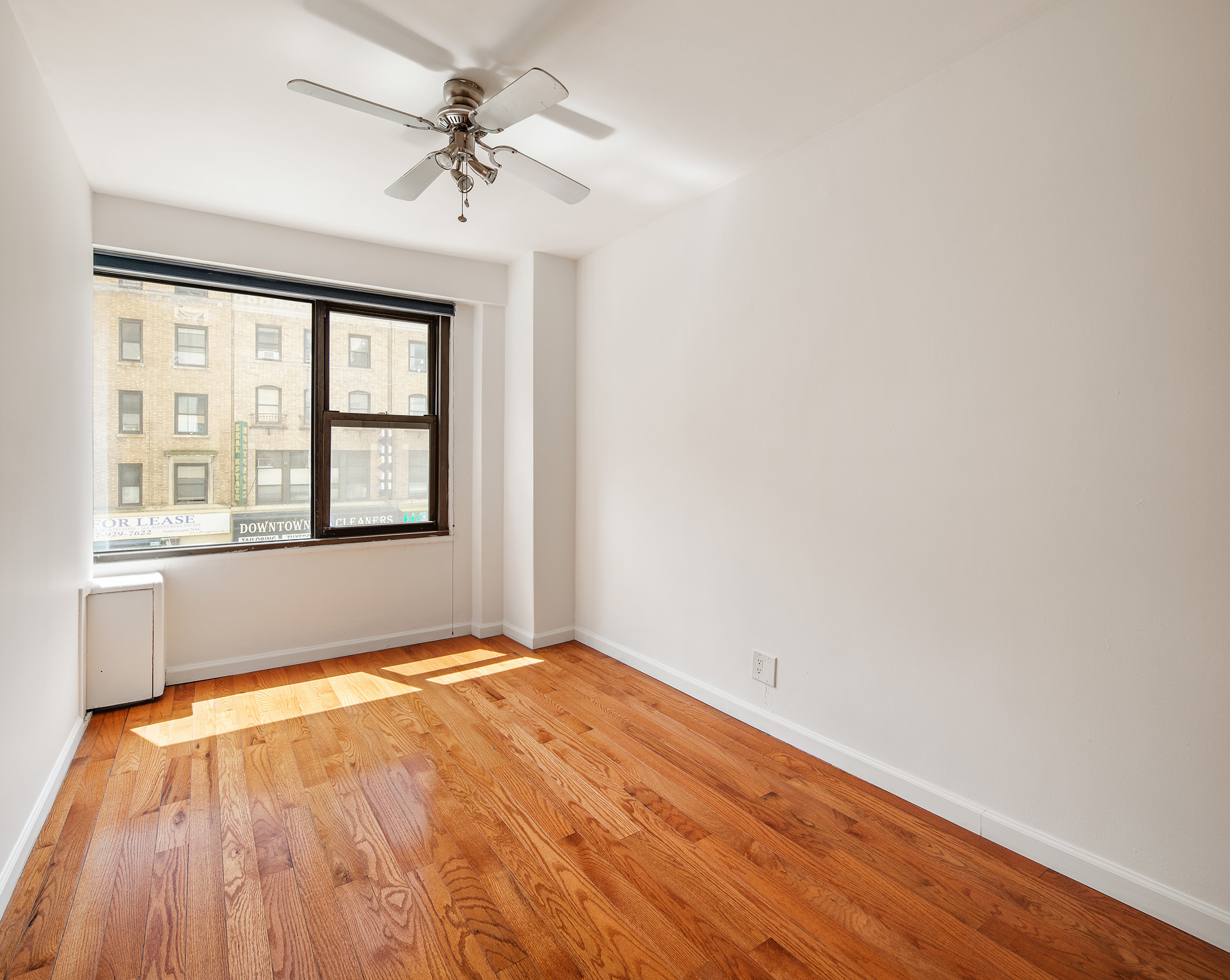 85 Livingston Street, Unit 3H Brooklyn, NY 11201 - Photo 6 of 9 an empty room with a window and a ceiling fan