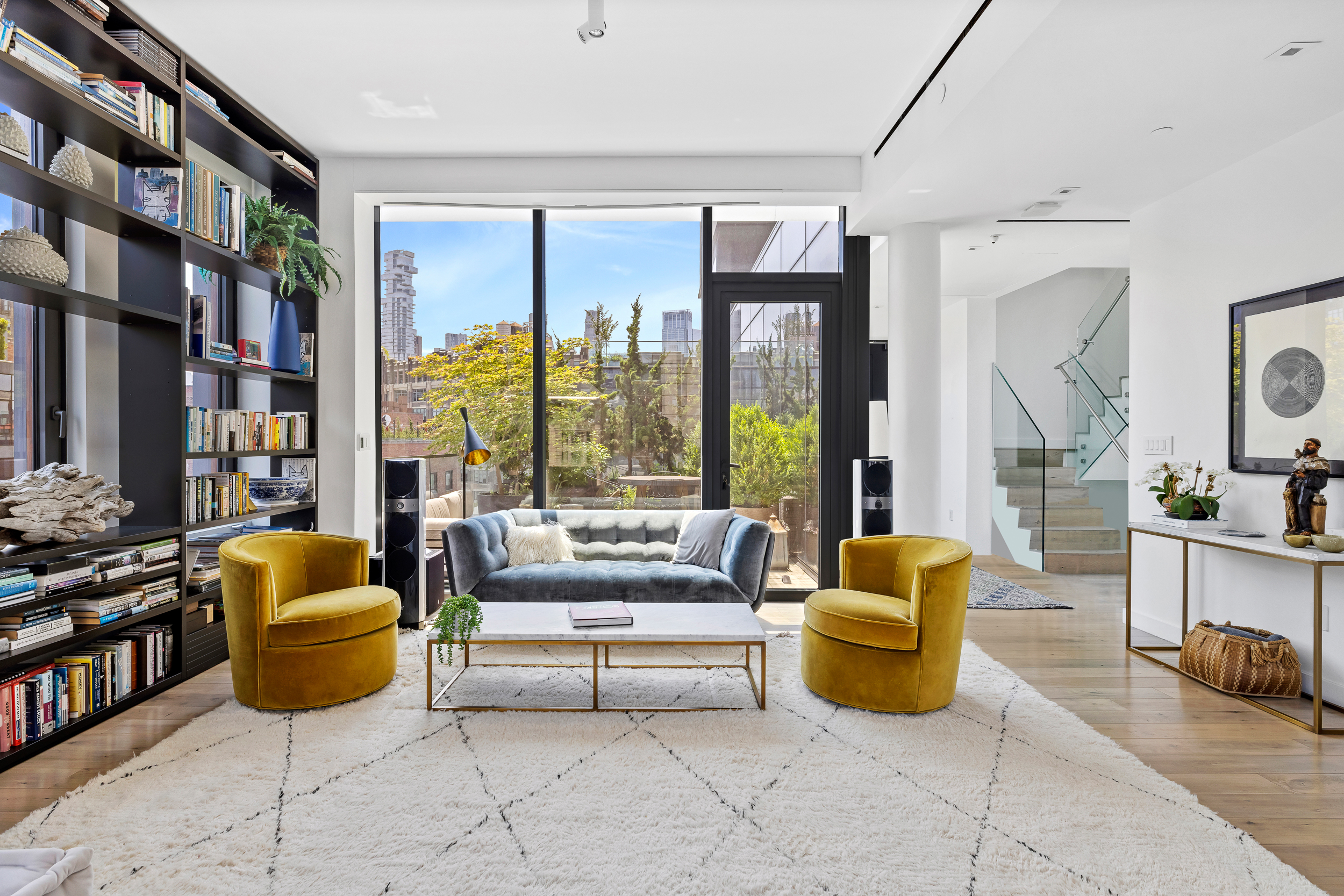 15 Renwick Street, Unit PH2 Manhattan, NY 10013 - Photo 4 of 23 a living room with furniture a rug and a large window