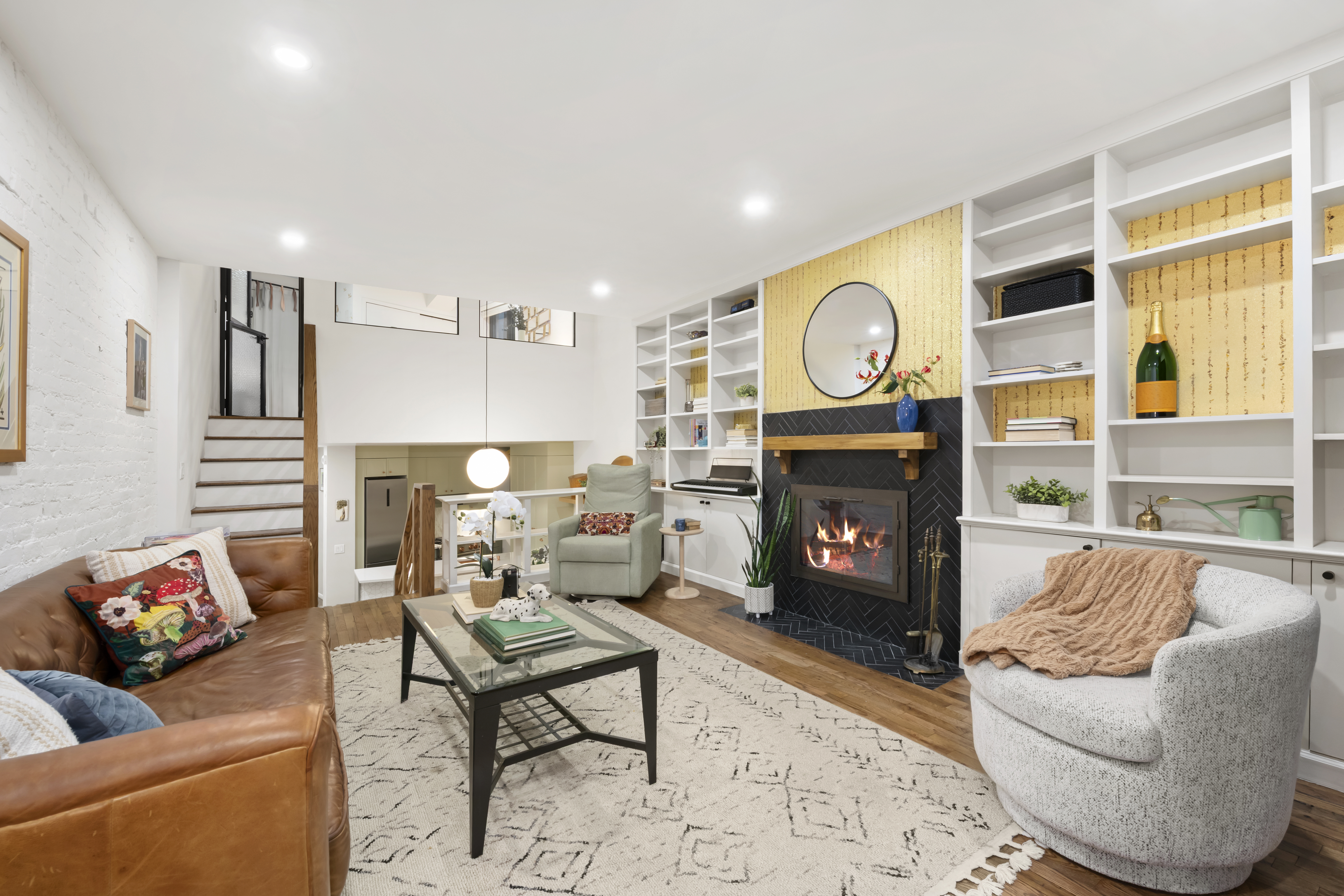49 East 12th Street, Unit 4A Manhattan, NY 10003 - Photo 2 of 6 a living room with furniture a fireplace and a large window