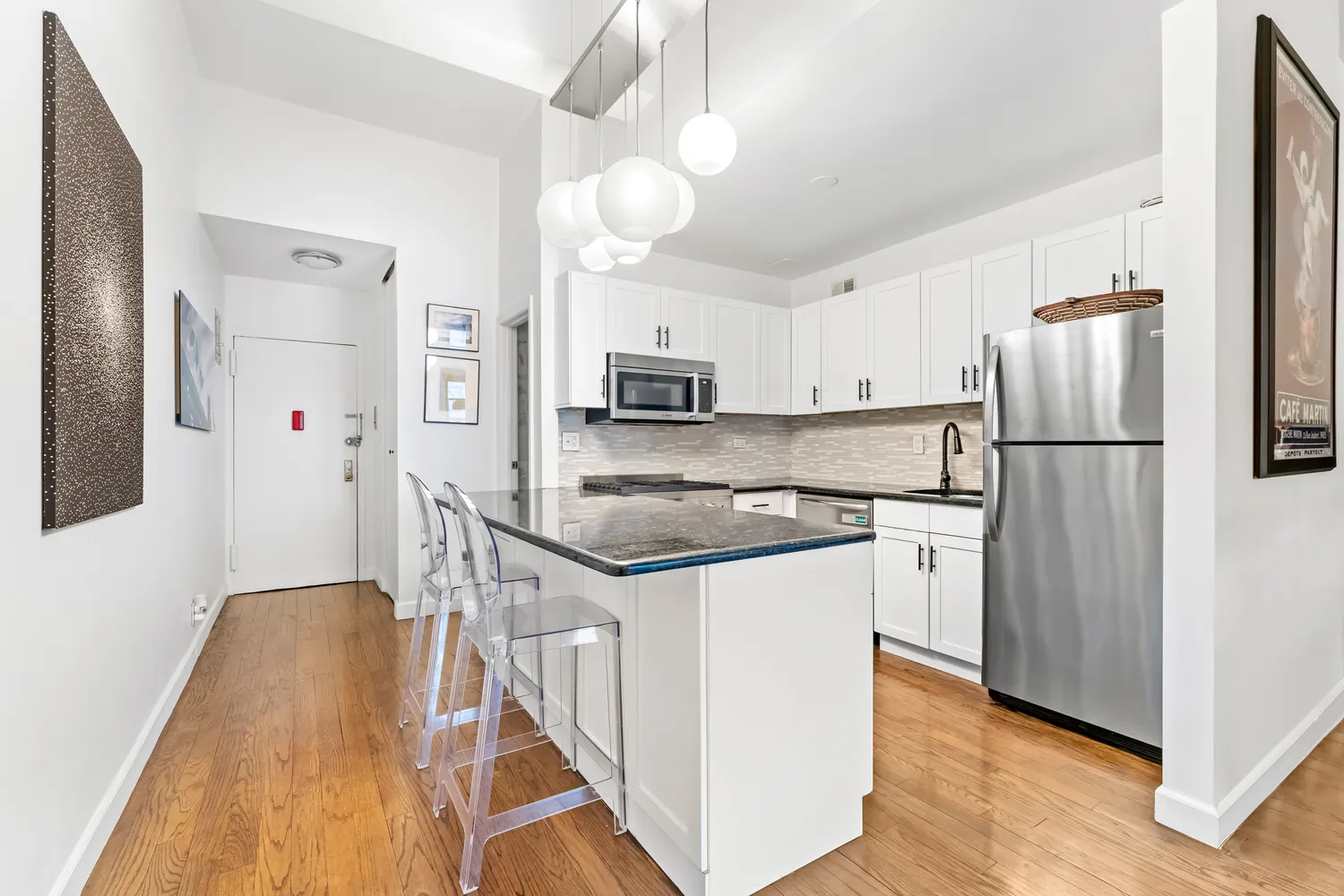 a kitchen with stainless steel appliances granite countertop a refrigerator a stove and a sink