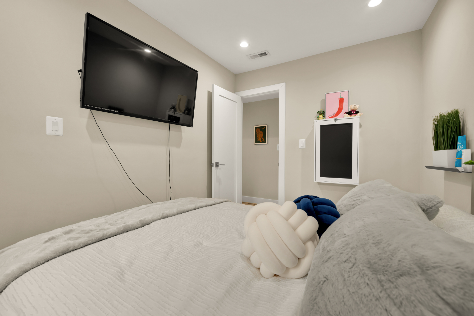 14 T Street Northeast, Unit 1 Washington, DC 20002 - Photo 25 of 39 a bedroom with a bed and a flat screen tv