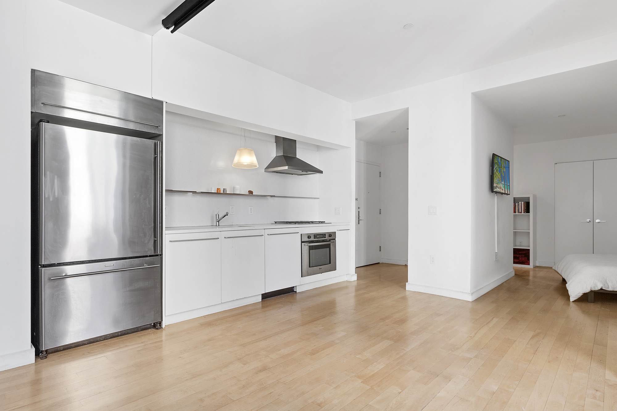 15 Broad Street, Unit 1601 Manhattan, NY 10005 - Photo 3 of 16 a kitchen with a refrigerator and a refrigerator