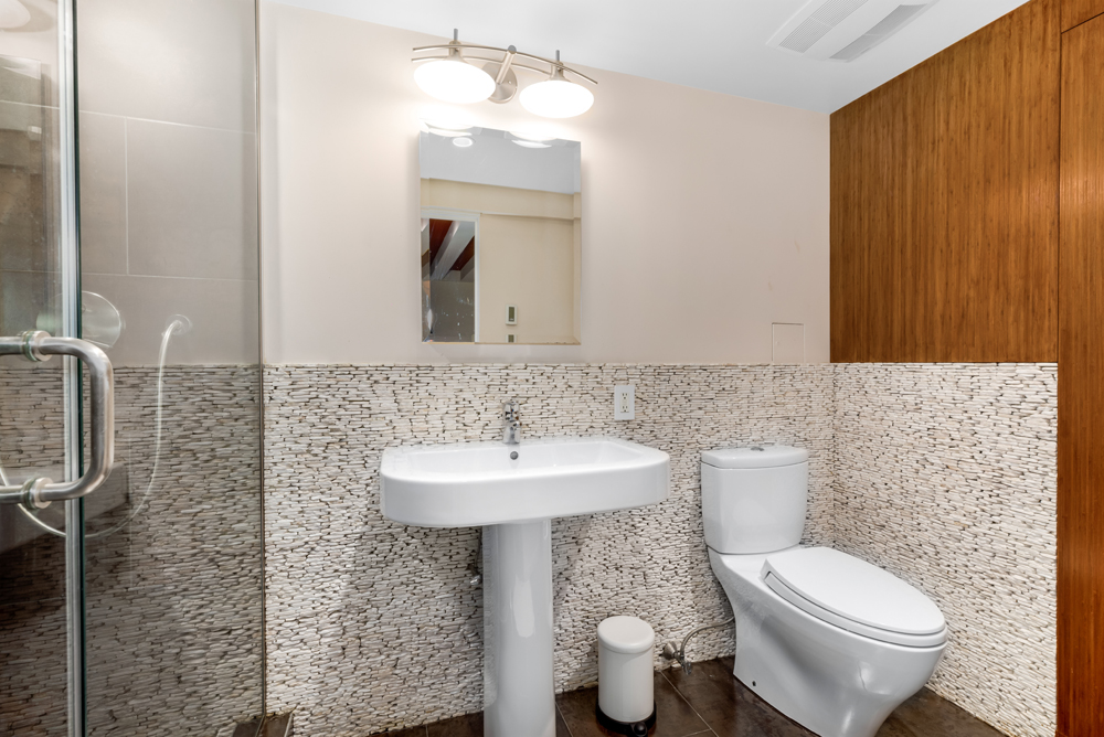 308 West 19th Street, Unit GARDEN Manhattan, NY 10011 - Photo 17 of 18 a bathroom with a toilet sink and mirror