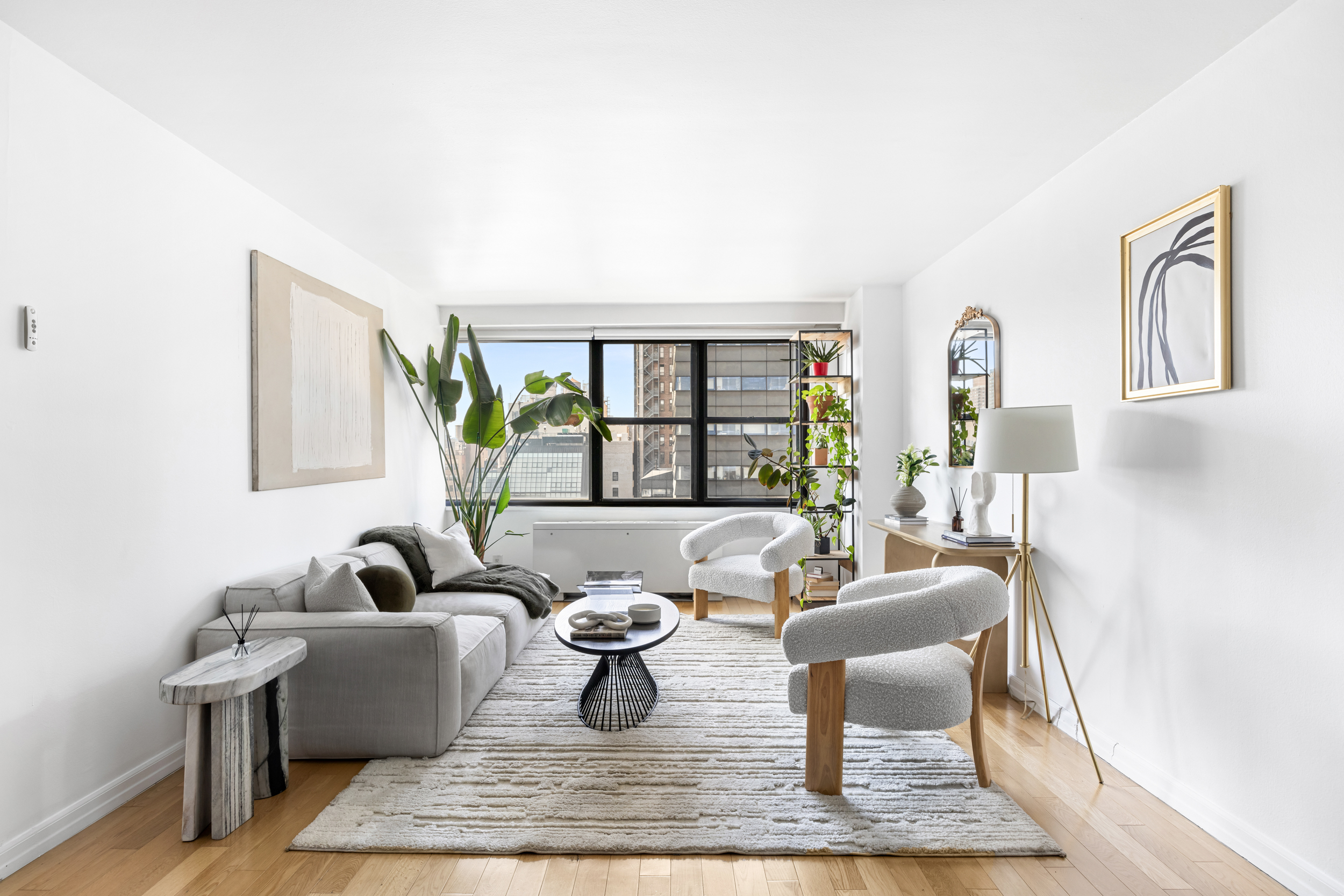 7 East 14th Street, Unit 17G Manhattan, NY 10003 - Photo 2 of 8 a living room with furniture and a window