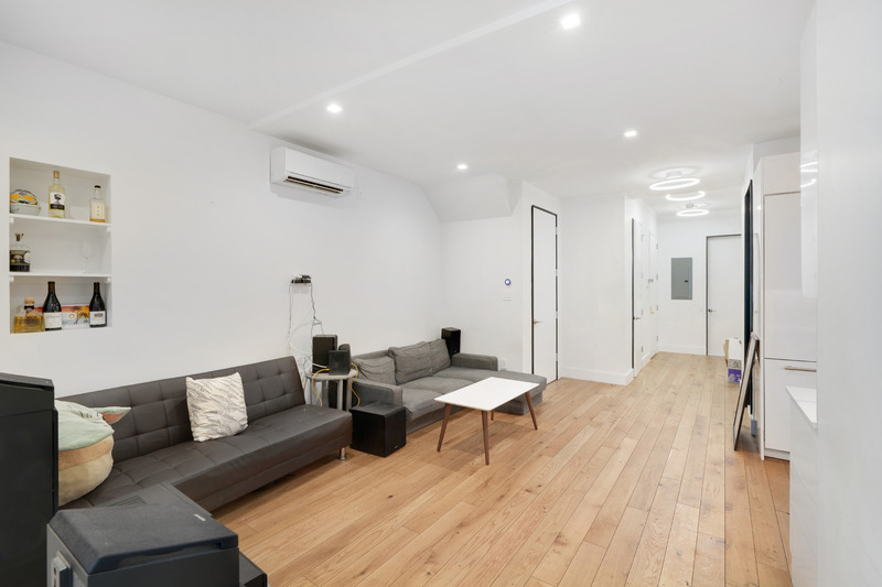 100 2nd Avenue, Unit 2 Manhattan, NY 10003 - Photo 2 of 10 a living room with furniture and a wooden floor