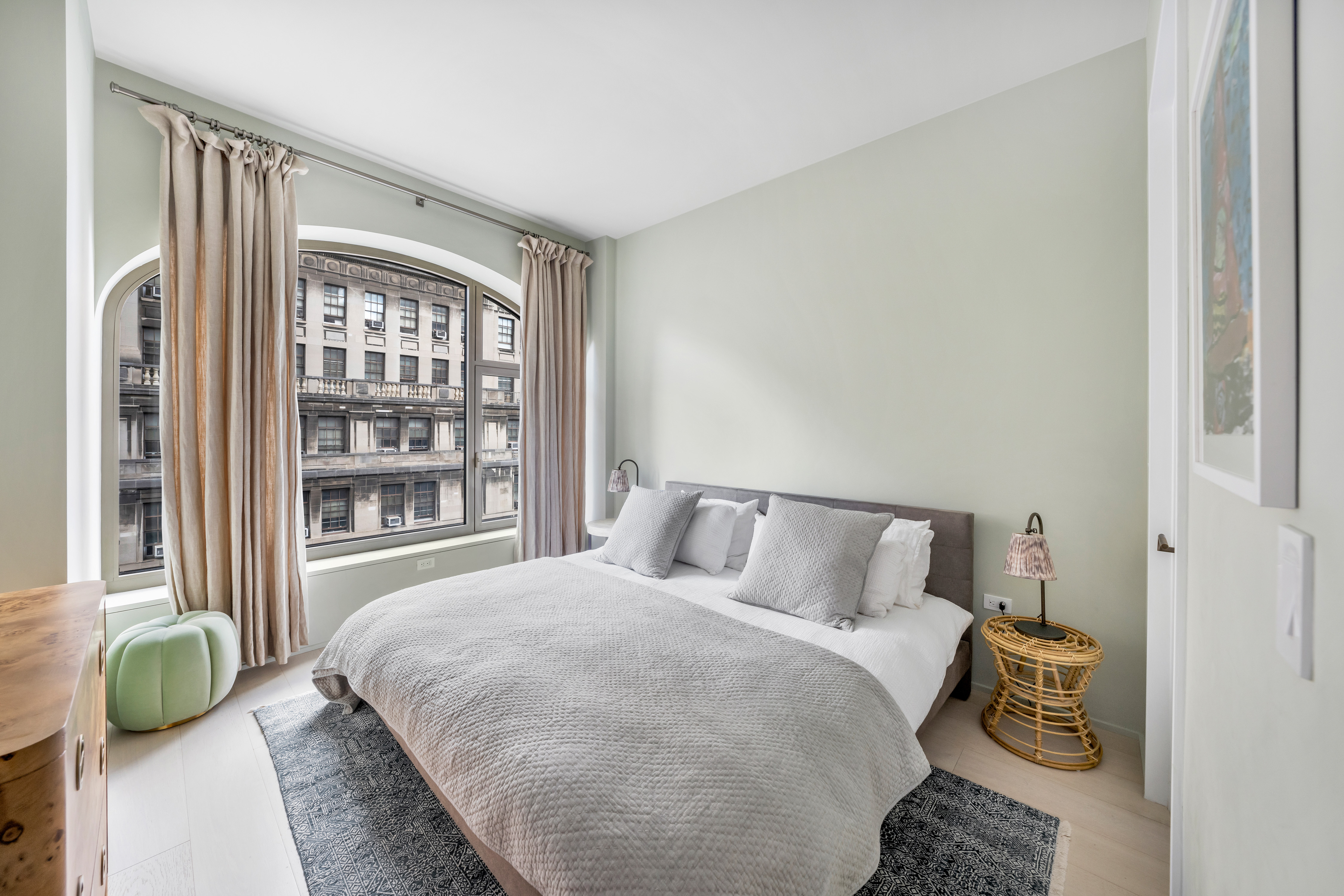 130 William Street, Unit 21A Manhattan, NY 10038 - Photo 6 of 9 a bedroom with a bed and a window