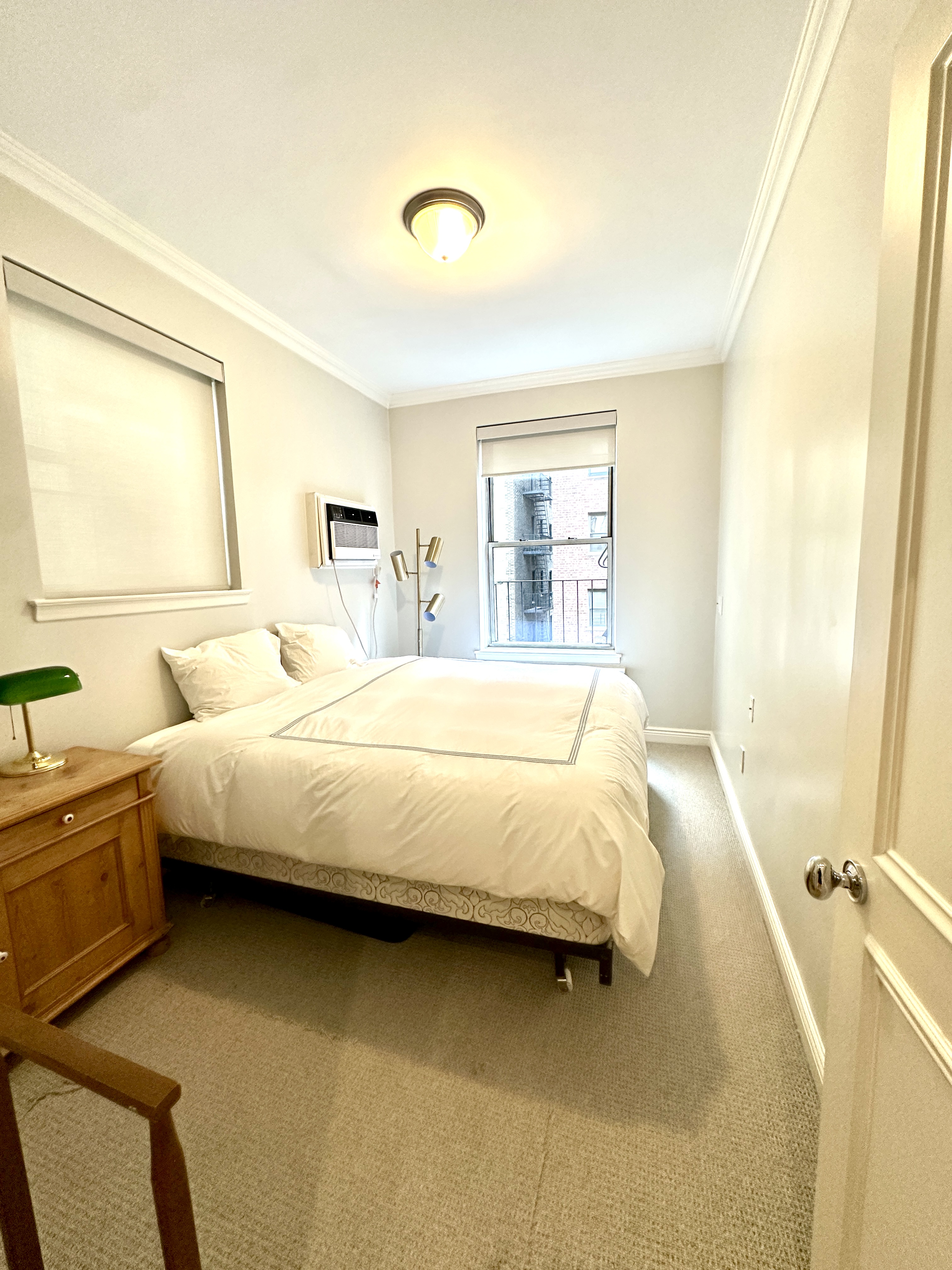 20 East 88th Street, Unit 5B Manhattan, NY 10128 - Photo 5 of 8 a spacious bedroom with a bed and a window
