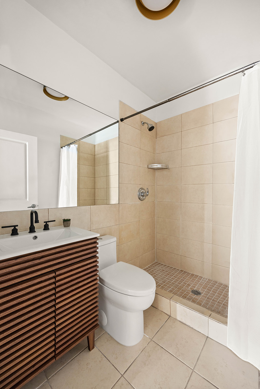 2233 Caton Avenue, Unit 2C Brooklyn, NY 11226 - Photo 8 of 10 a bathroom with a sink a toilet and shower