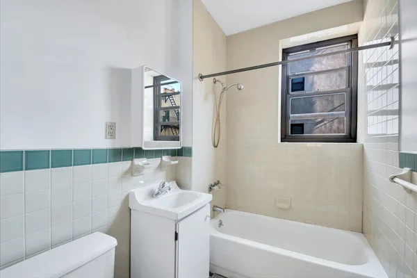 a bathroom with a bathtub a sink and a shower