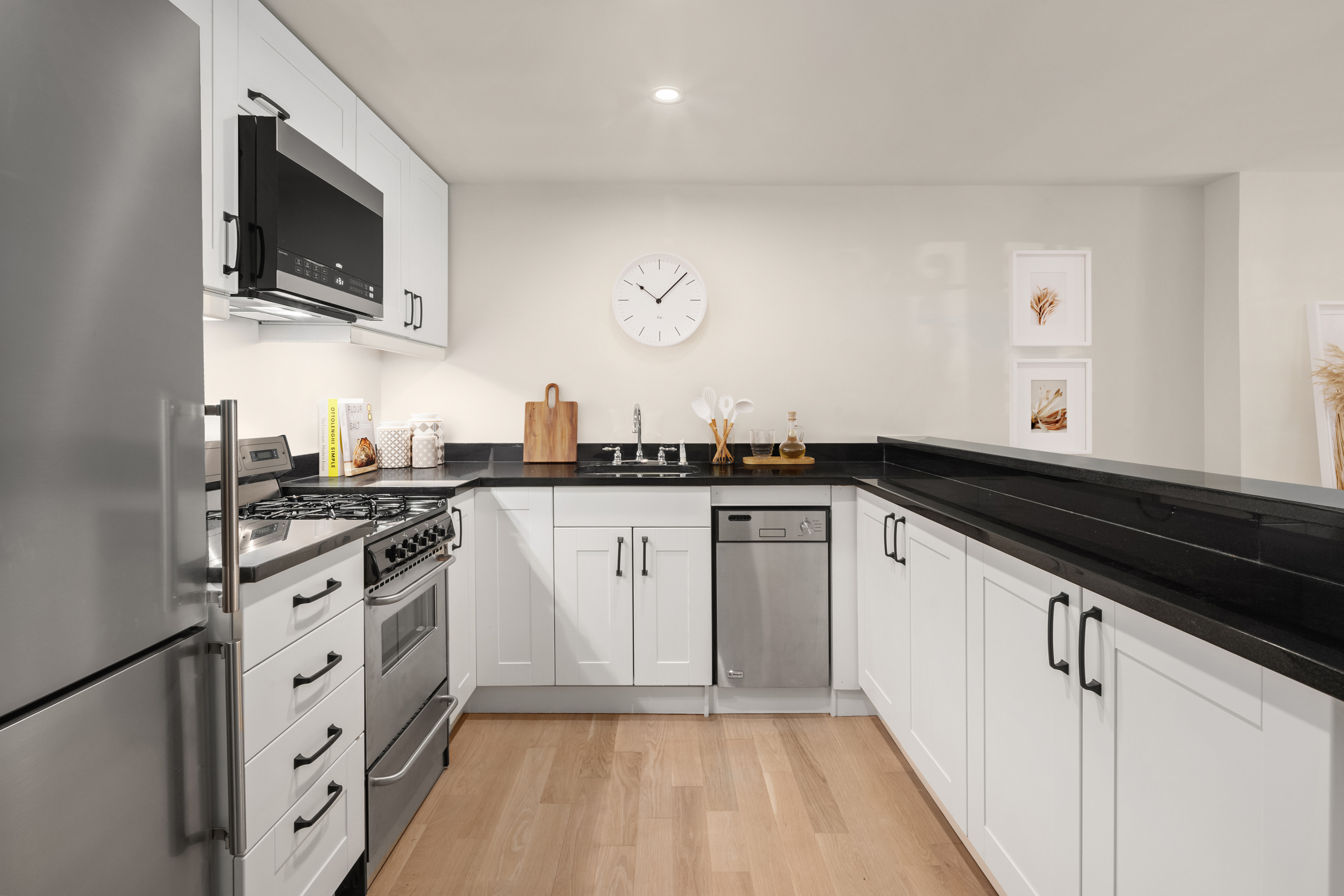 204 Warren Street Brooklyn, NY 11201 - Photo 22 of 29 a kitchen with granite countertop a sink dishwasher stove and white cabinets