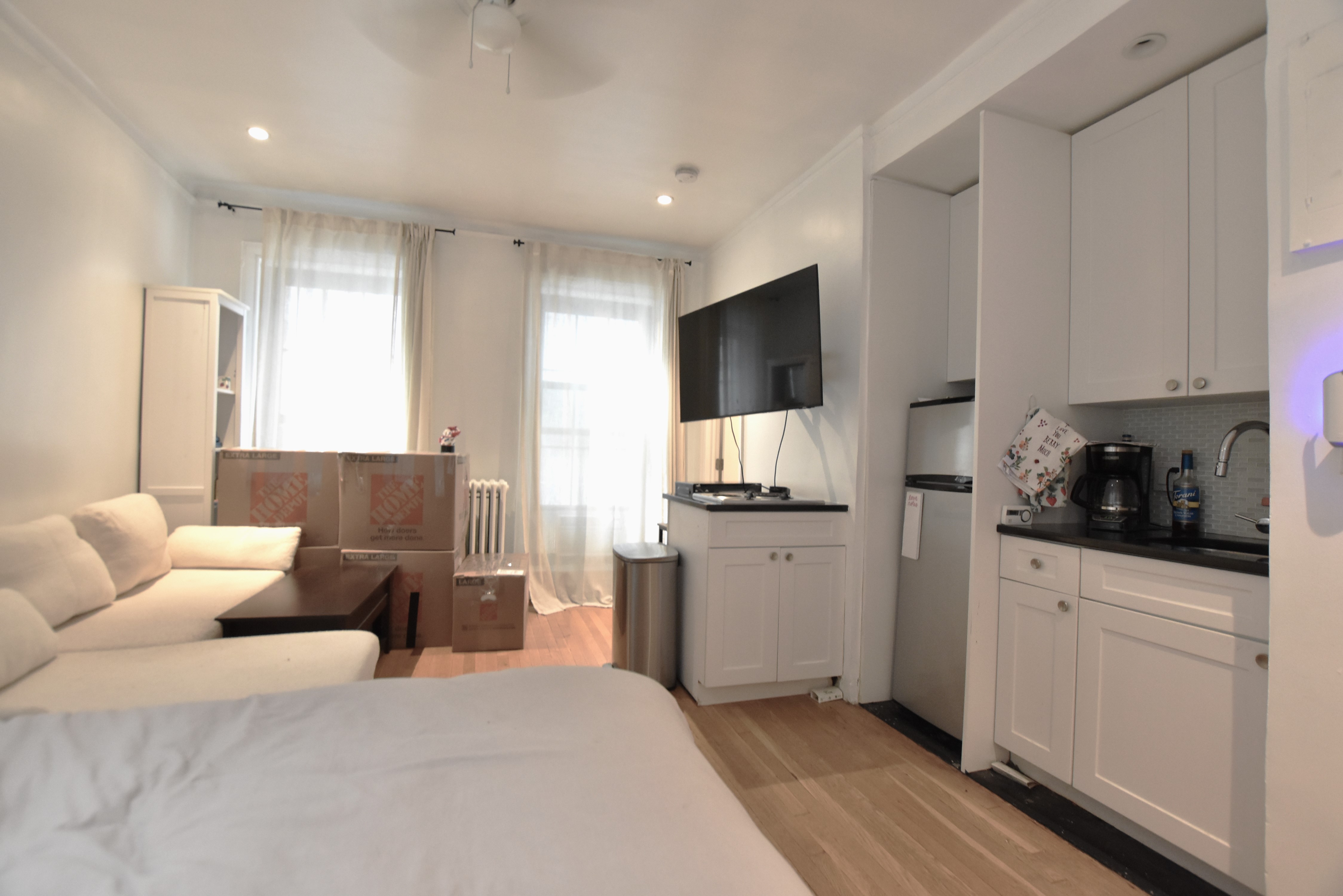 172 5th Avenue, Unit 2F Manhattan, NY 10010 - Photo 6 of 10 a large bedroom with a bed and flat tv screen