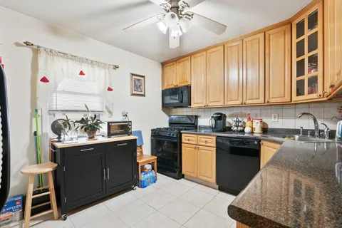 a kitchen with a stove a sink and a refrigerator