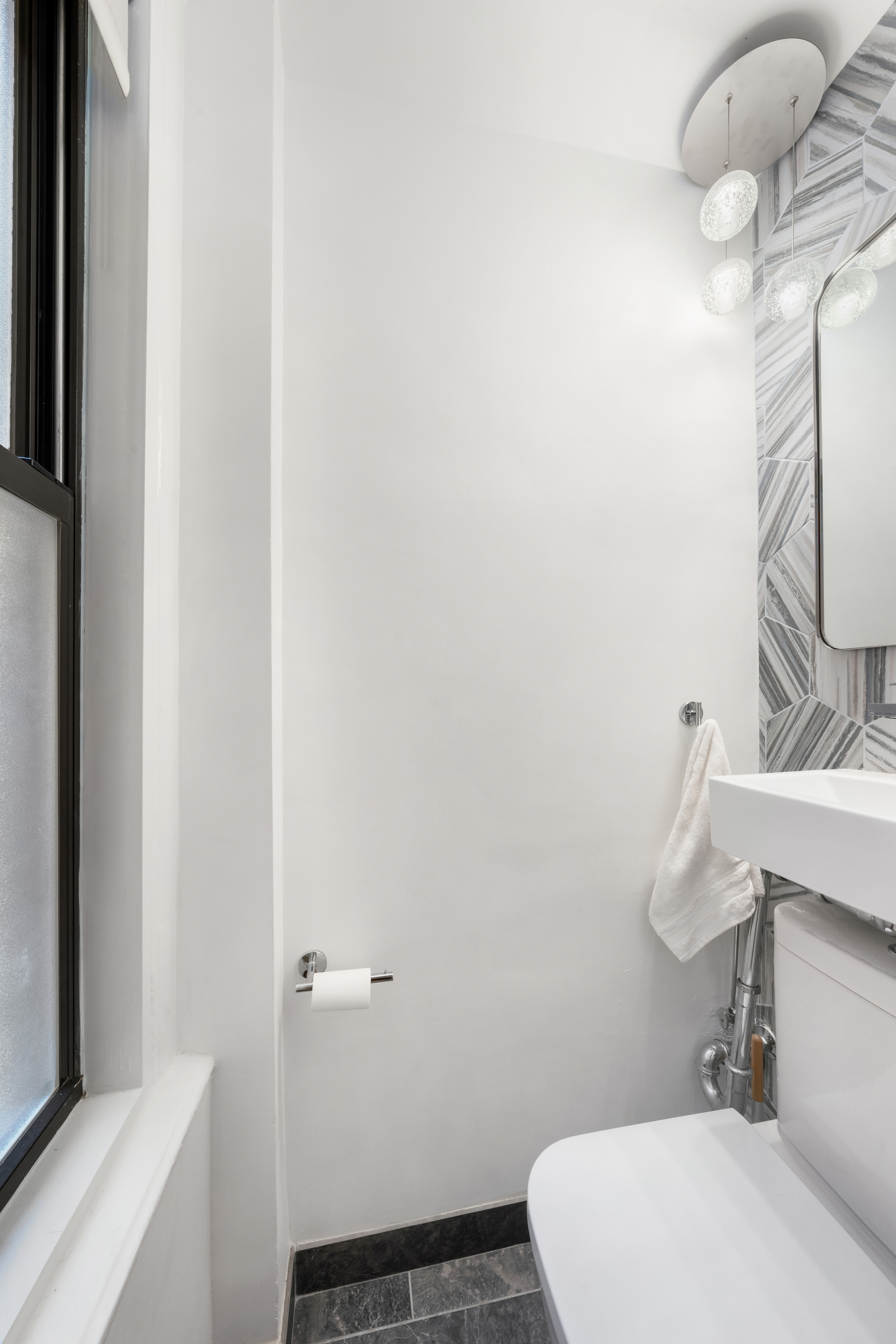 150 West 55th Street, Unit 5D Manhattan, NY 10019 - Photo 8 of 12 a bathroom with a sink and toilet