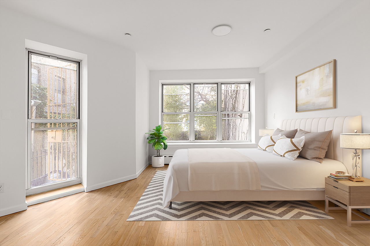 239 East 7th Street, Unit 1 Manhattan, NY 10009 - Photo 7 of 9 a bedroom with a bed and wooden floor
