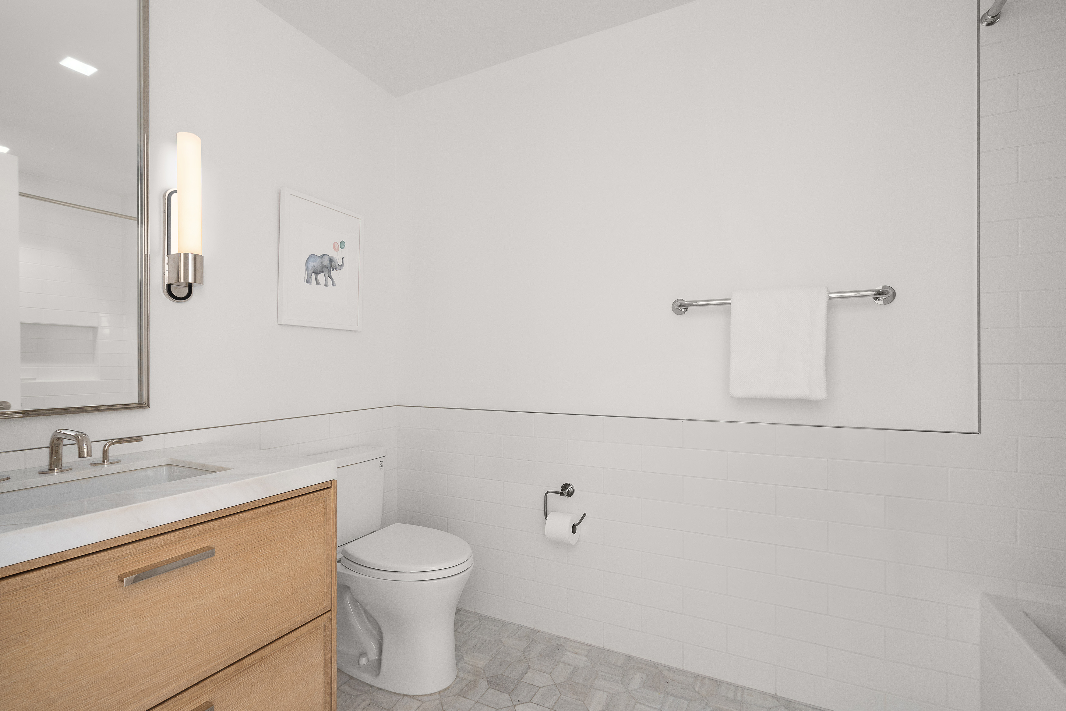 200 East 83rd Street, Unit 4E Manhattan, NY 10028 - Photo 13 of 29 a bathroom with a toilet sink and mirror