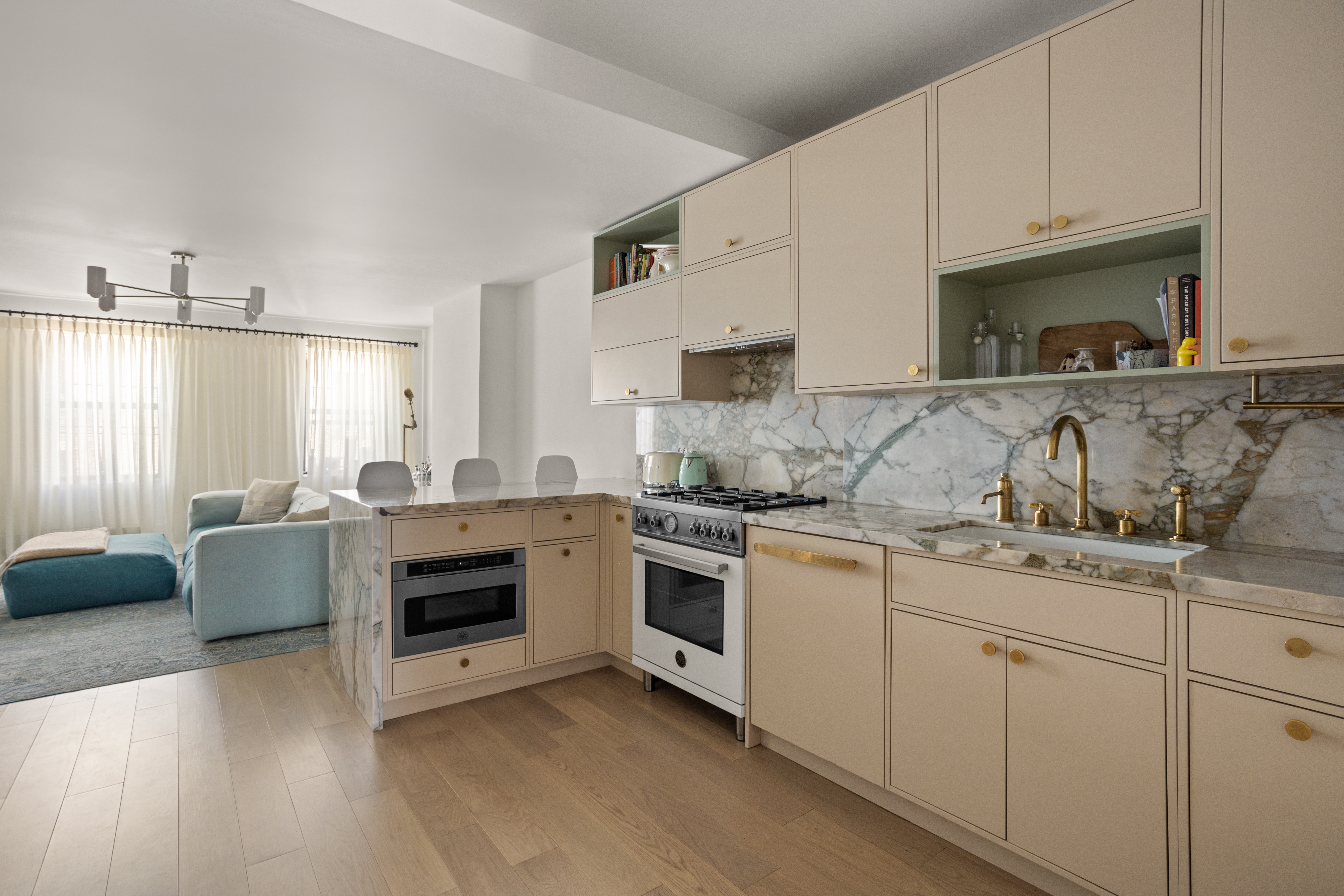537 East 6th Street, Unit 5 Manhattan, NY 10009 - Photo 7 of 12 a kitchen with granite countertop white cabinets and white appliances