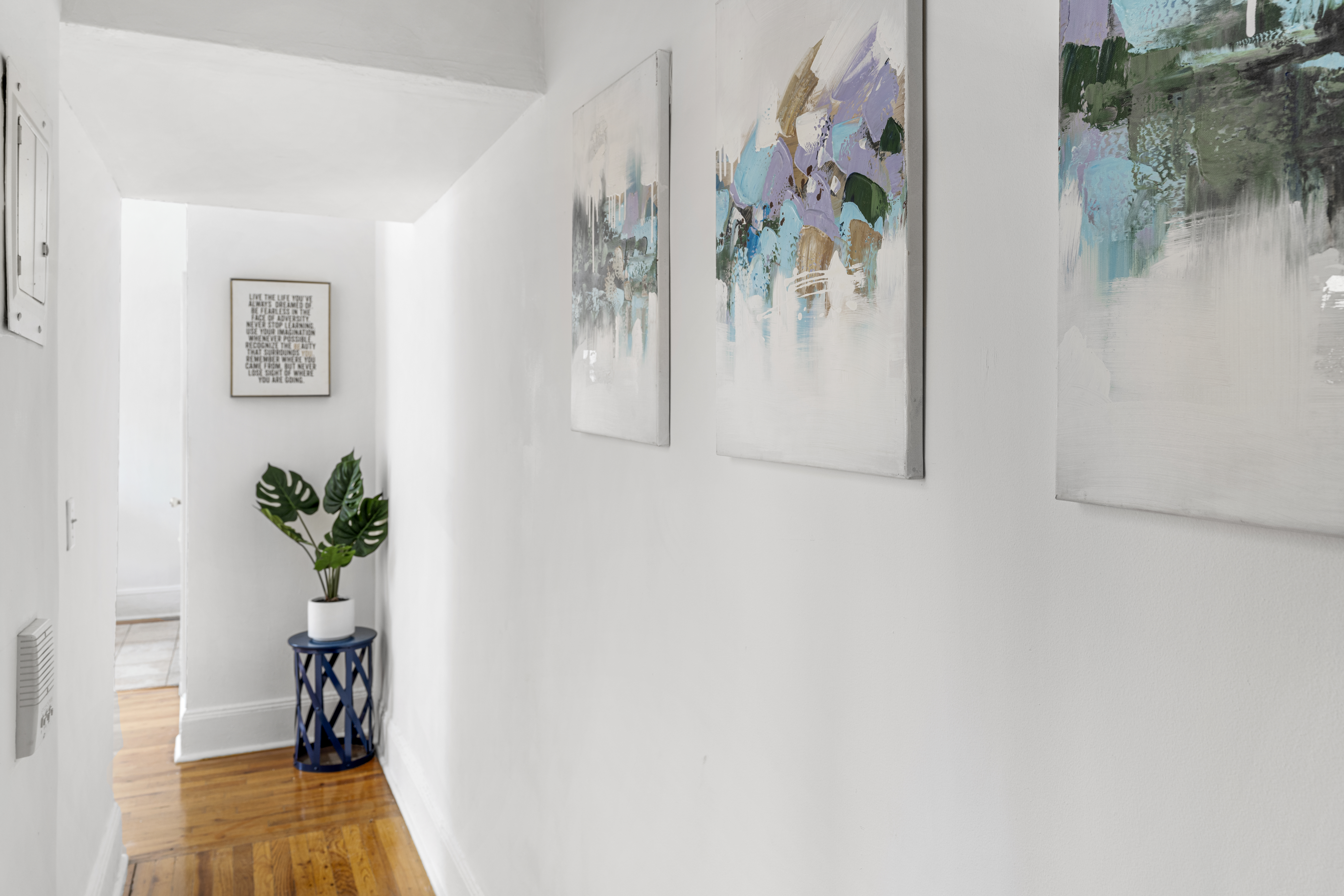 458 West 20th Street, Unit 3D Manhattan, NY 10011 - Photo 3 of 9 a view of a hallway with wooden floor and a dining room