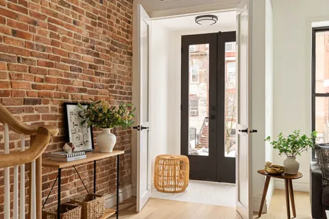 a front view of a house with outdoor seating