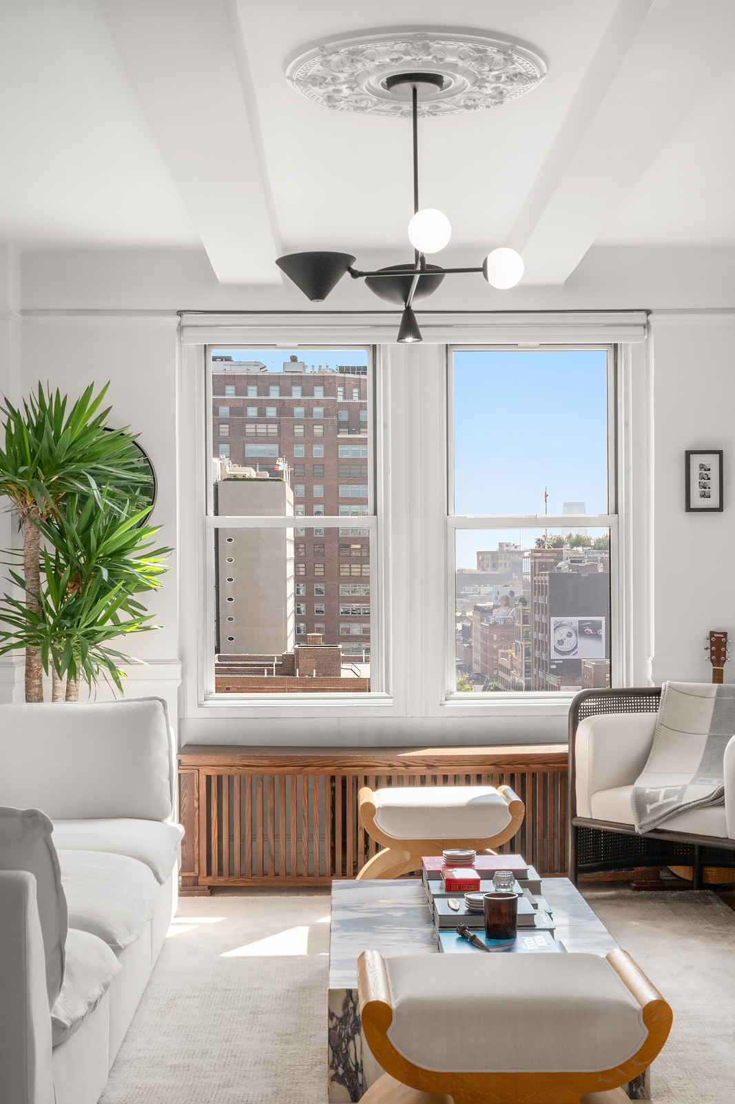 365 West 20th Street, Unit 14B Manhattan, NY 10011 - Photo 2 of 21 a living room with furniture and a large window