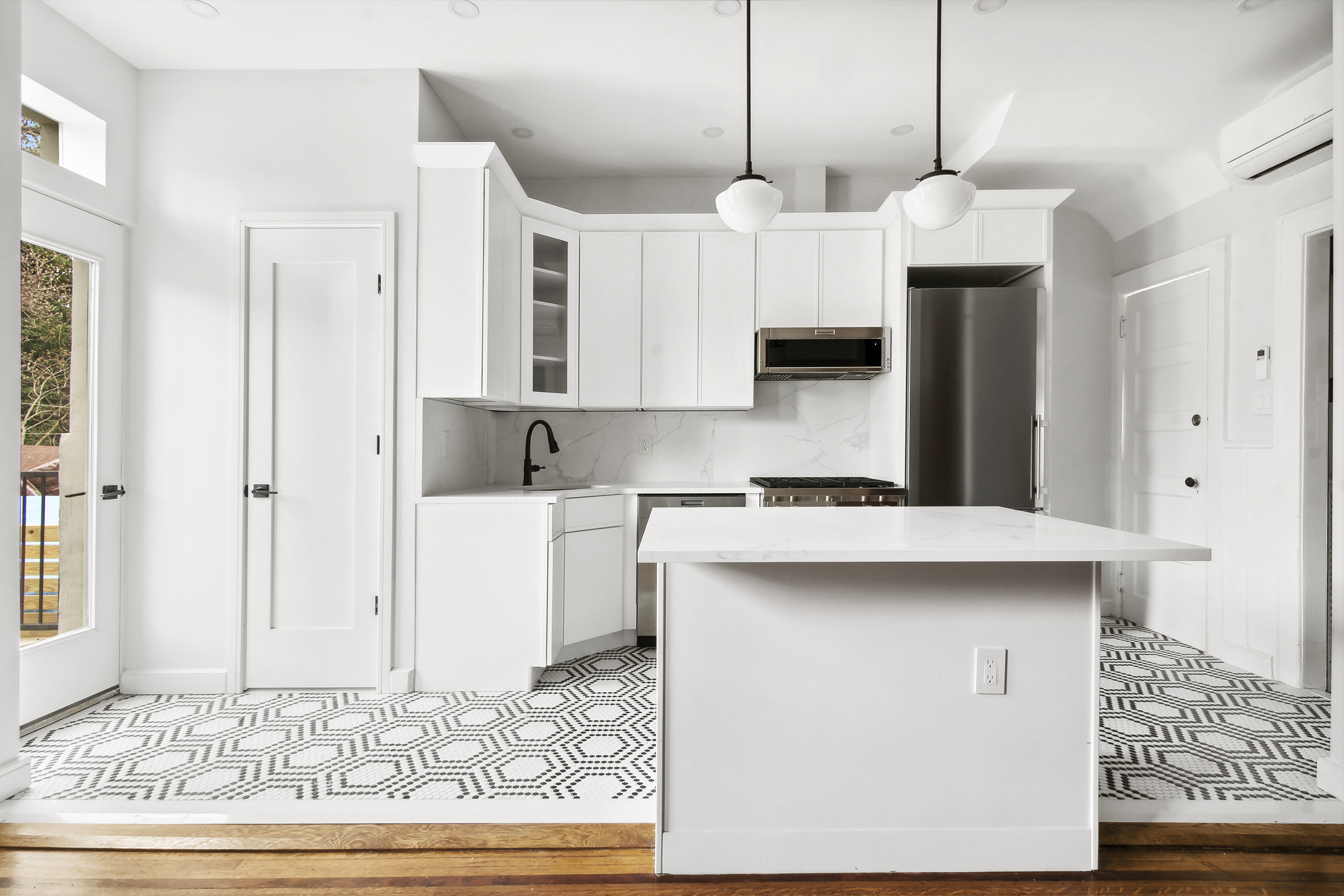 195 Rutland Road Brooklyn, NY 11225 - Photo 7 of 21 a kitchen with kitchen island granite countertop a stove a sink and a refrigerator