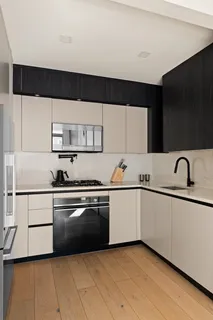 a kitchen with a sink and white stainless steel appliances