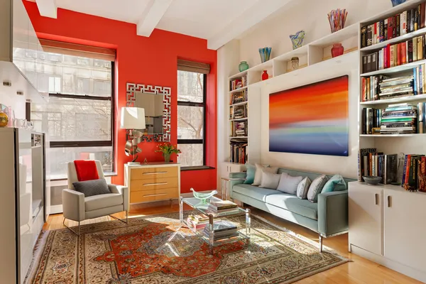 a living room with patio furniture and a book shelf