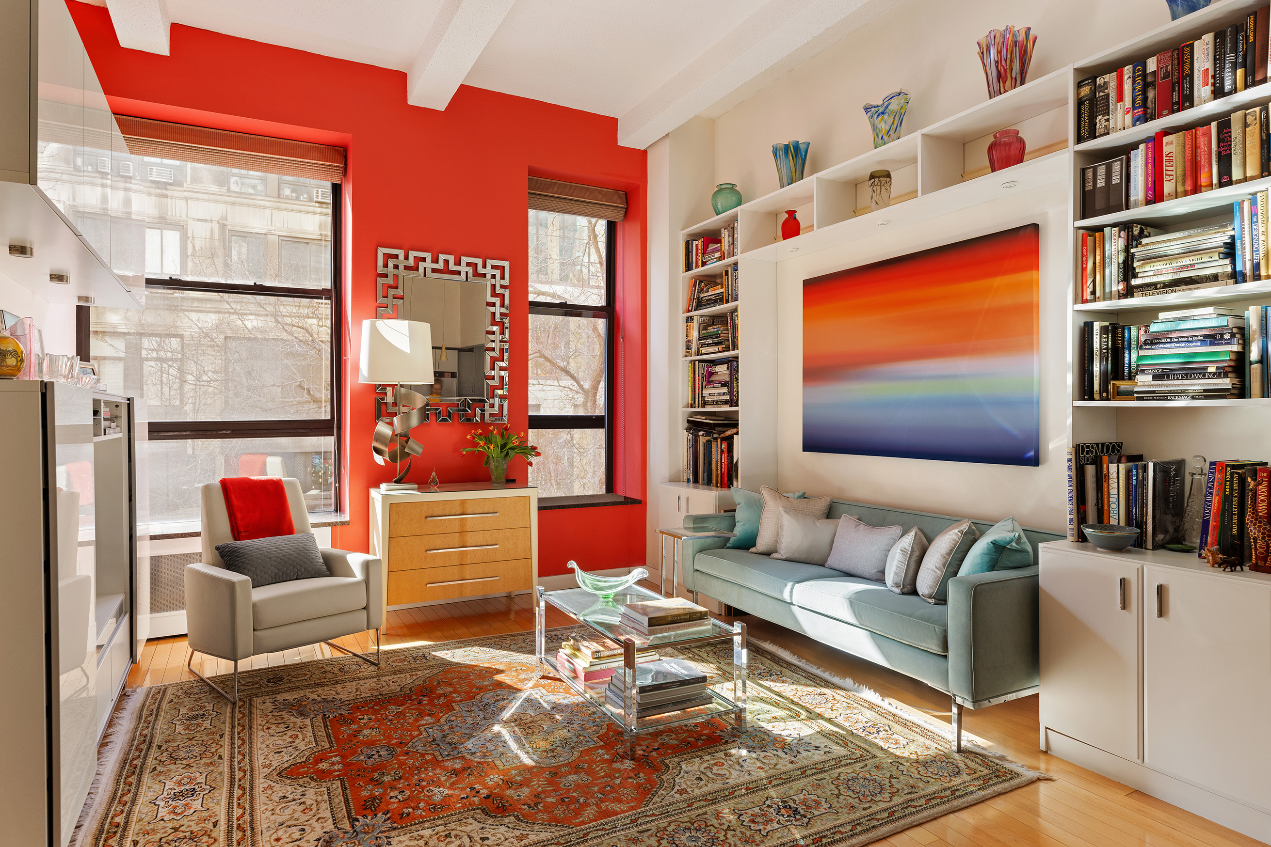 a living room with patio furniture and a book shelf