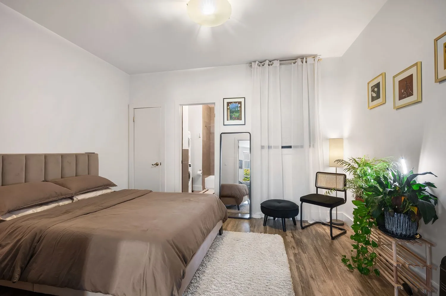 a bedroom with a bed and a potted plant